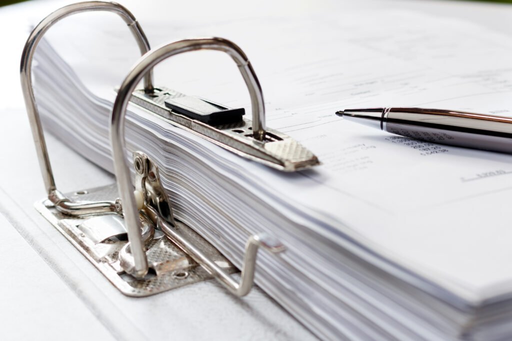 Business pen on file folder with documents, storage of contracts. selecti