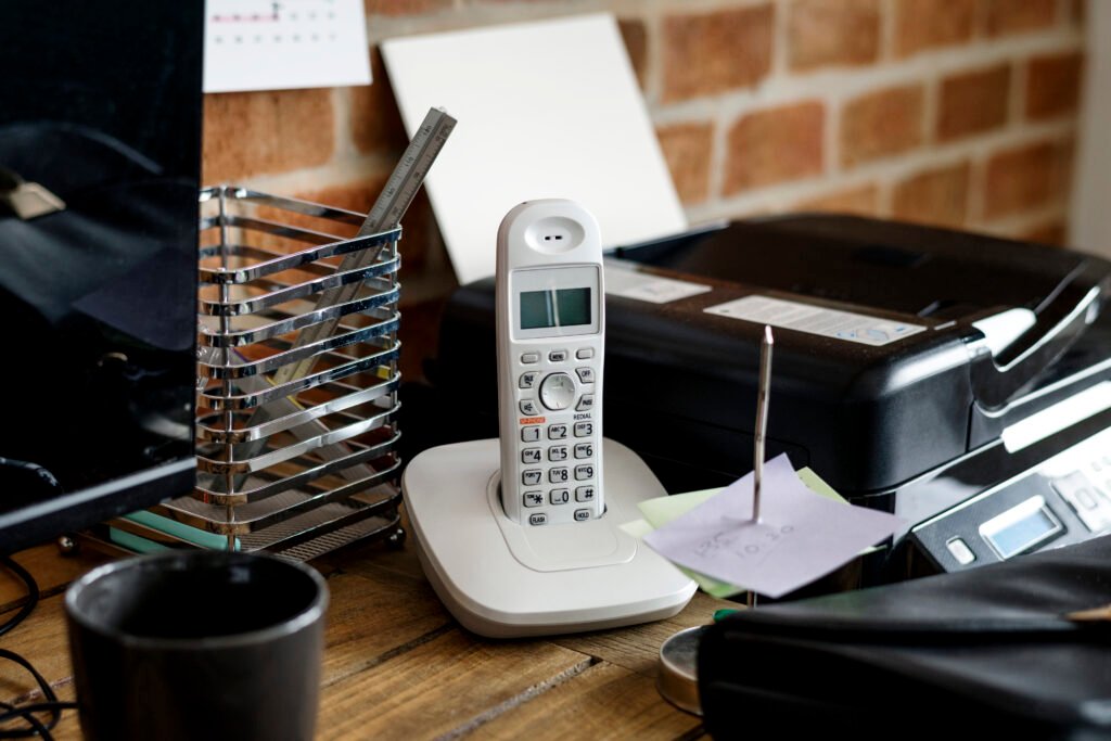 Business closeup of landline phone on wooden table